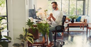 Man, remote work and happy at computer with fist pump, good news and positive feedback for article made for content syndication.